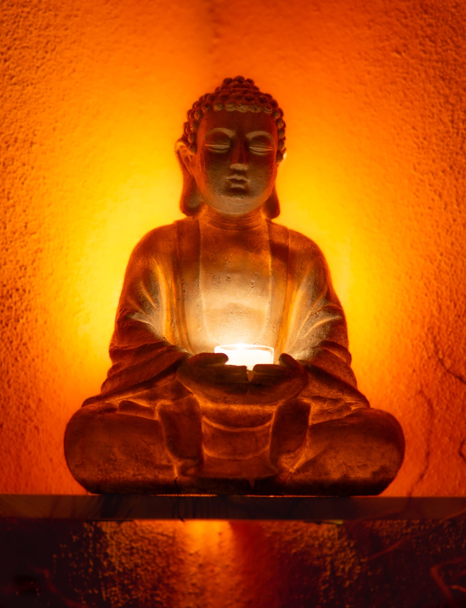 Buddha figure by candlelight